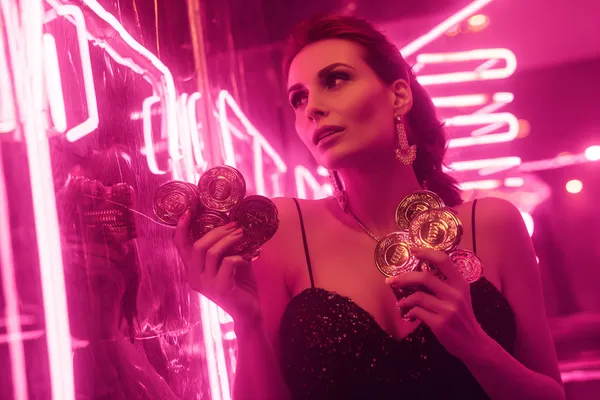 A glamorous woman holding casino chips in a neon-lit environment, representing the premium online casino atmosphere of A71.